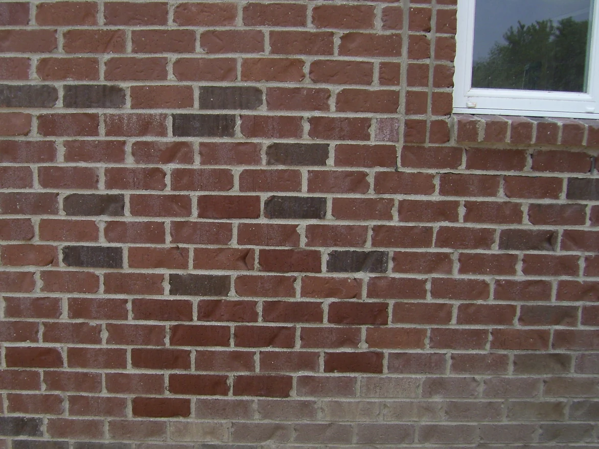 The same wall and window with the pale bricks brought down to the depth of the units beside them, the courses reading as one red range