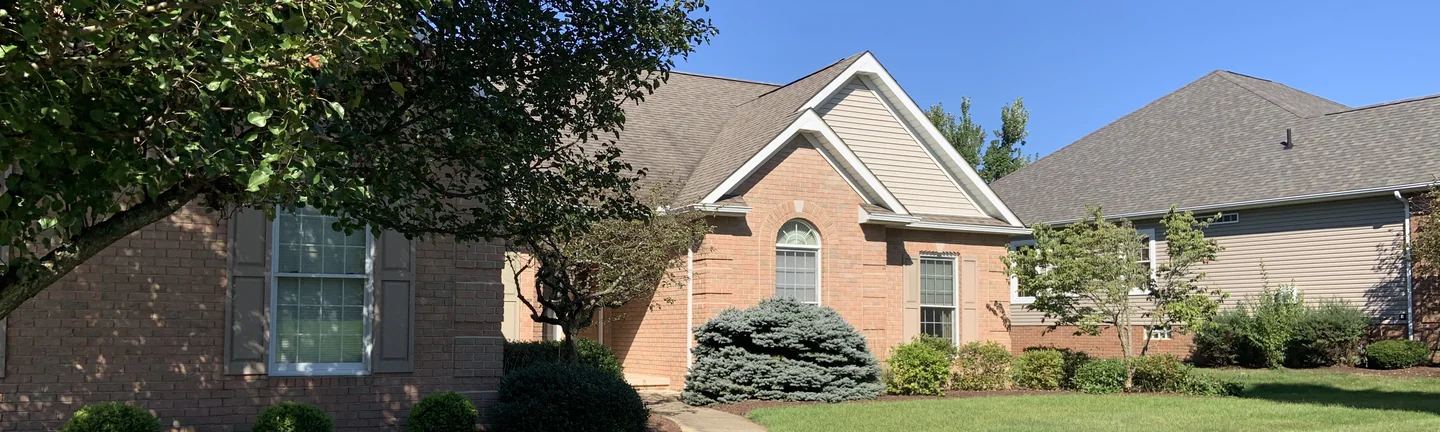 A single-story brick house in Massillon seen from the front lawn in 2019, its brick one even red range