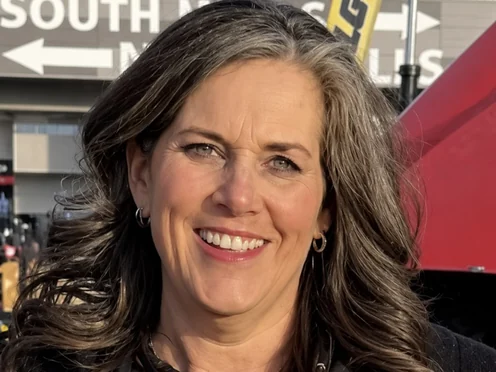 Peggy Schneider-Foster in a black Masonry Cosmetics polo at an outdoor trade show
