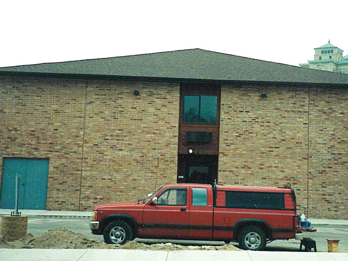 The same gable end in 1999 after the work, the buff brick now carrying an even scatter of browns and tans across the whole wall