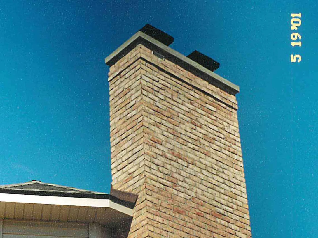 The chimney from below in 2001, the brick in its upper section a pale grey buff against the warmer tan units further down