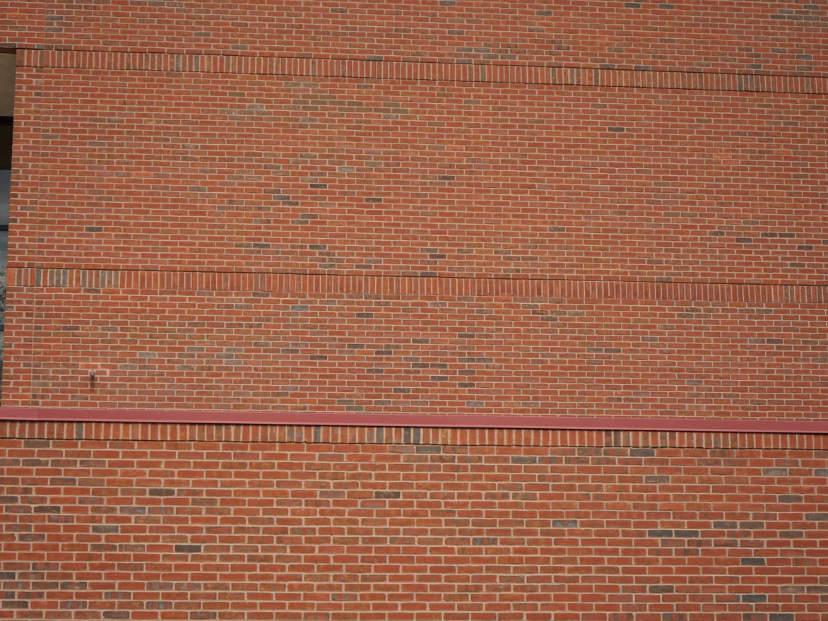 Two courses of upright soldier brick crossing a red brick wall in 2019, the upright units sitting in the same range as the brick above and below them