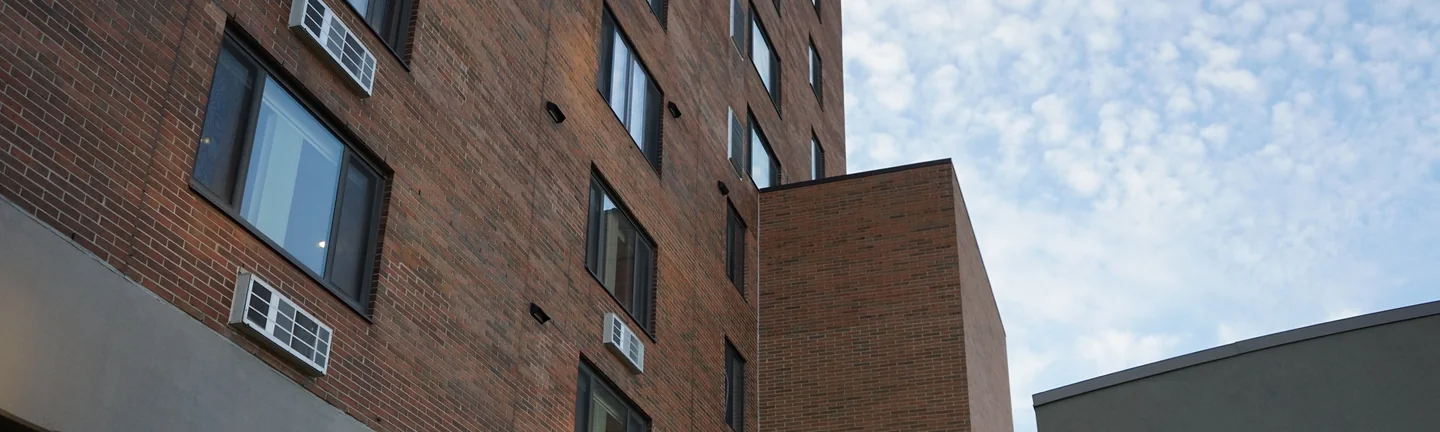 The Michigan high rise in 2019, the added elevator shaft reading in the same red and tan brick as the tower