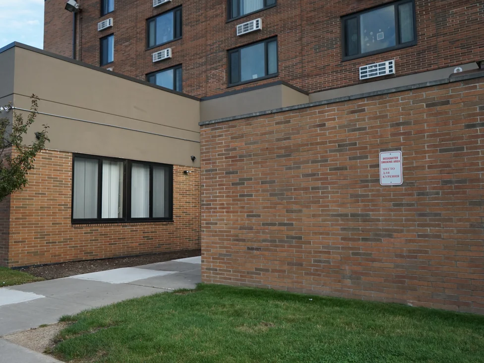 Brick at close range in 2019 at the foot of the tower, an even mix of orange reds and dark browns running the length of the wall