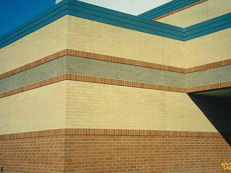 The same corner in 2002 after staining, the upper courses reading as one cream tan range above the grey band and the orange brown base, with a camera date of 7/2/2002 in the corner