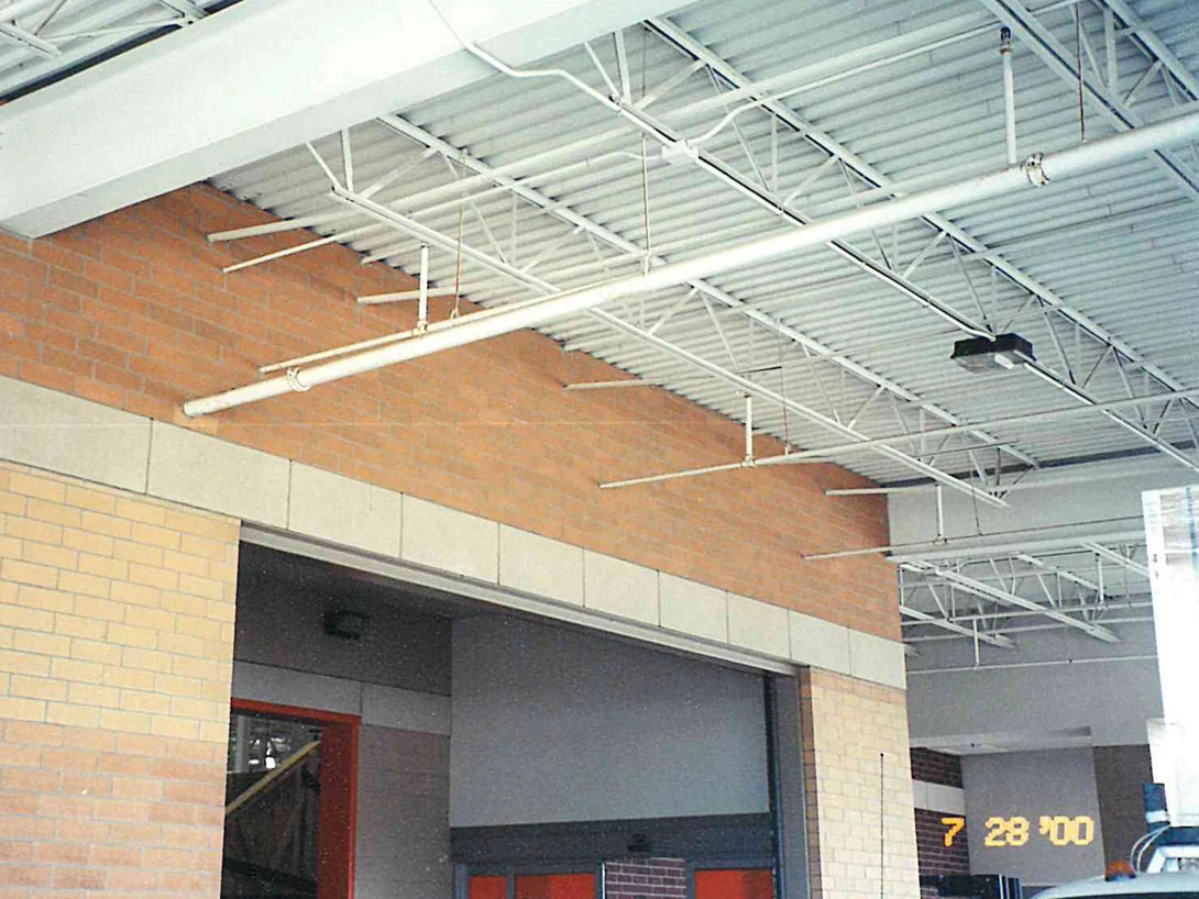 A canopy bay in 2000, the pier below the beam a pale cream and the brick above it an orange tan, with open steel deck overhead