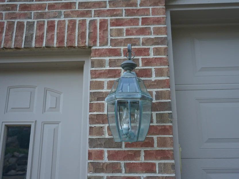 Close view of the brick beside a coach lantern in 2019, individual units running through red, brown, grey and cream with pale mortar joints and a soldier course above