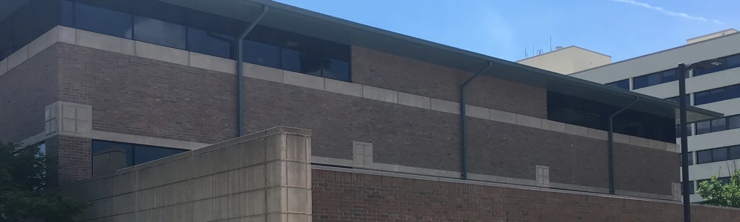The brick elevation of the hospital in 2019, even in color above and below a cream precast screen wall