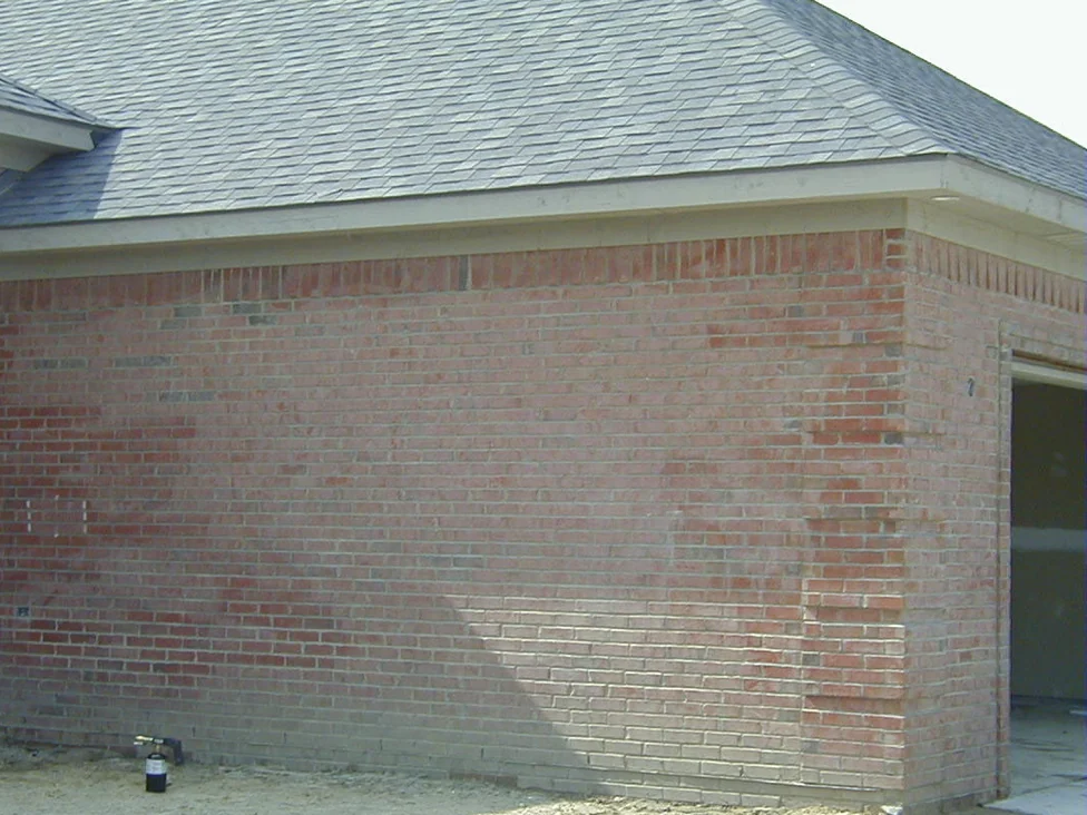 The garage end of the house in 2004, the new brick marked with pale washed-out patches where power washing had pulled the color out