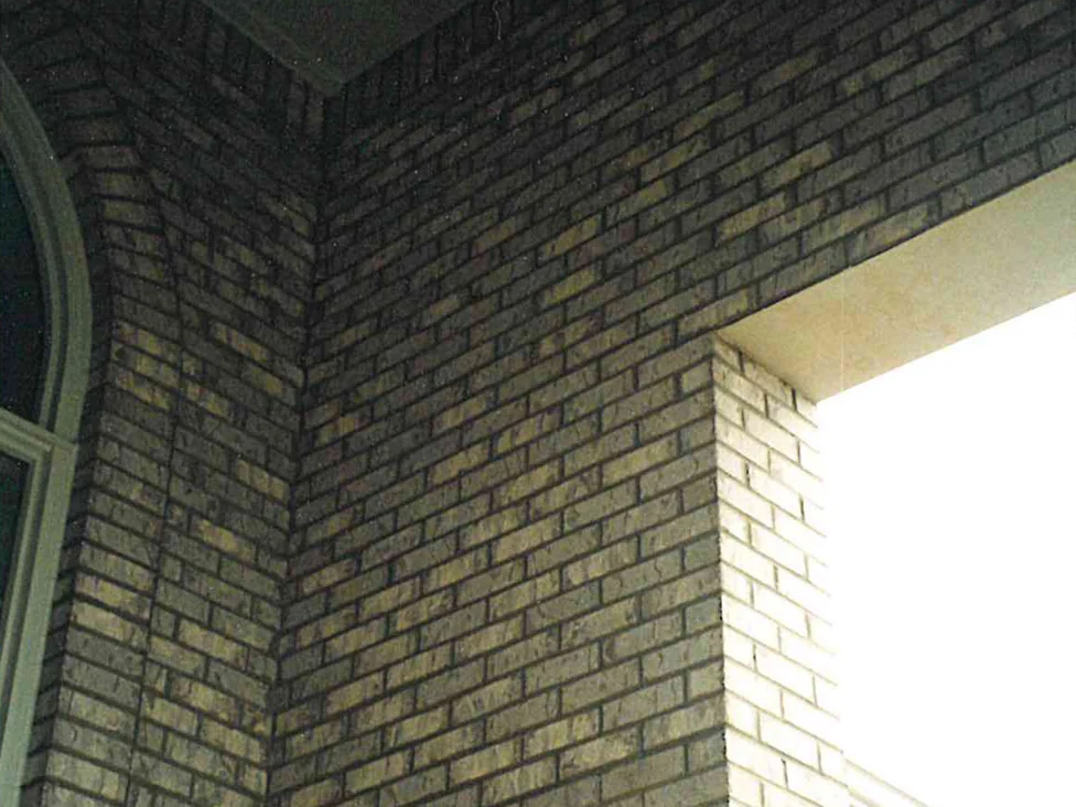The recessed entry in 1998, the brick on the shaded return reading far darker than the pale units on the pier beside it