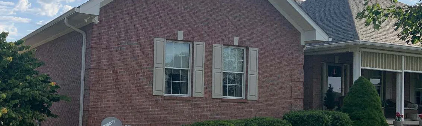The gable end of the Mooresville house in 2019, its brick one even salmon range from the lawn to the roofline
