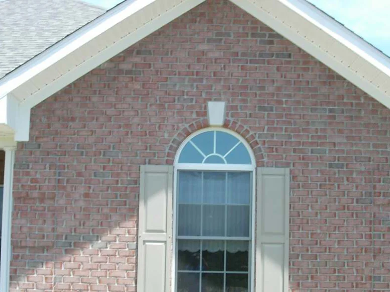 The same gable later in 2007, the brick carried to an even salmon range from the eaves down past the fanlight window