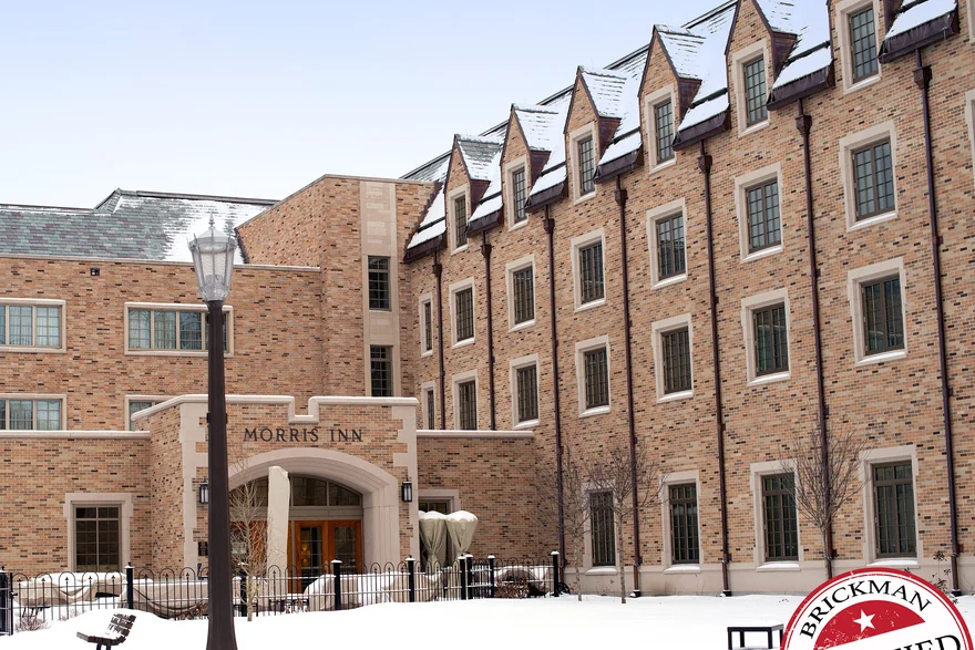 The Morris Inn on a university campus in Indiana in 2019, the carved name over the entrance and four storeys of brick reading as one even tone