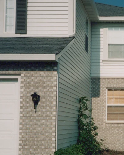 A house in Mundelein, Illinois in 1998, the stained face brick around the garage reading as one even wall