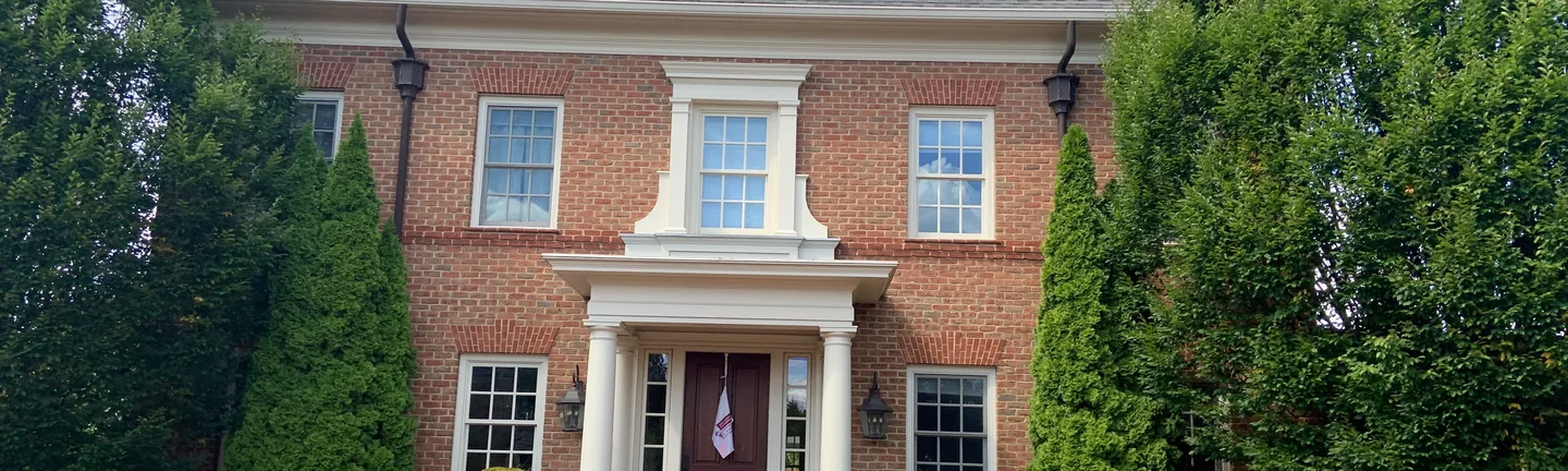 The front of the New Albany house in 2019, its jack arches reading a deeper red than the wall around them