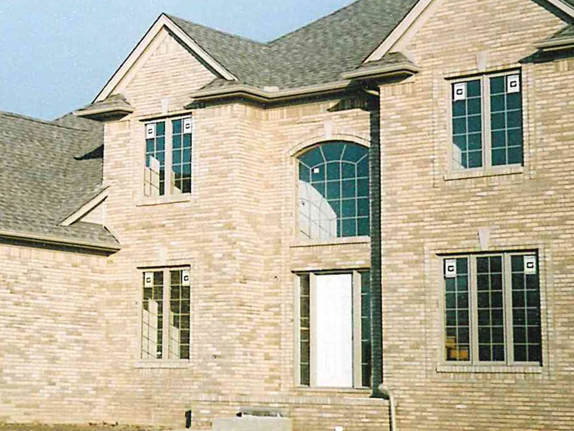 The entry gable and the arched window after the blend in November 2003, the units now sitting within one range from the ground to the peak