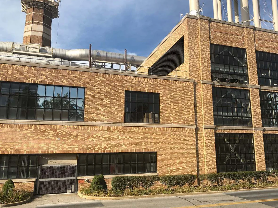The plant from the road in 2019, the addition and the original walls carrying the same brick color across the whole frontage