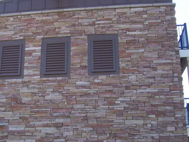 The same three vent wall in 2009 with the work finished and the lift gone, the stone now one range of red brown and tan under the same bright sun