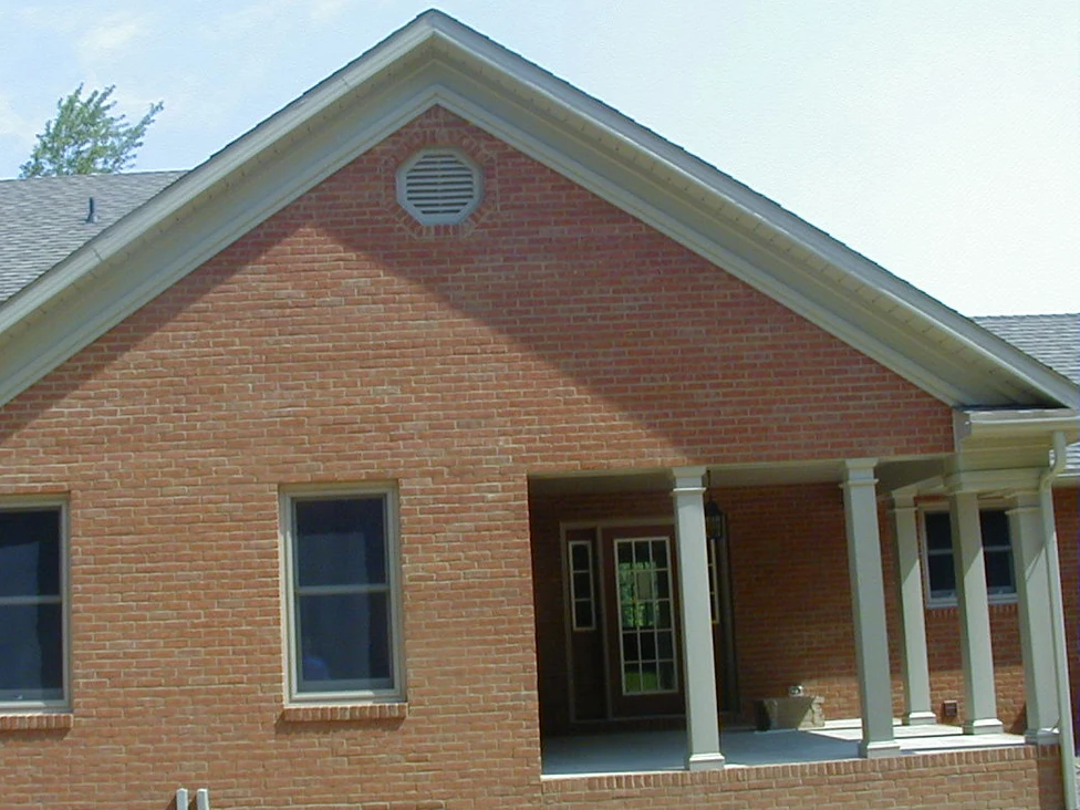 The same gable end and porch later in 2004, the brick reading as one deeper red range with the pale patches closed up and the joints carried closer to the brick around them