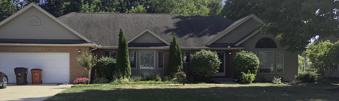 An Ohio ranch house from the street in 2019, its brick one even red across the front