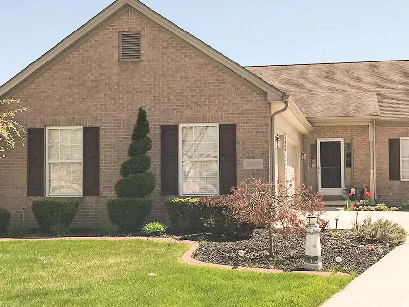 The front of the house in 2019, the gable end and the entry carrying the same brick color across the whole frontage