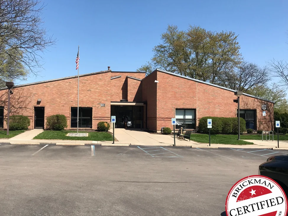 An Ohio library in 2019, one range of red brick running across both wings under a low roofline