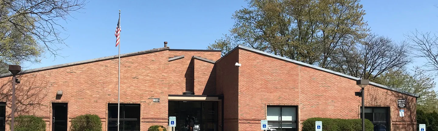 An Ohio library in 2019, one range of red brick running across both wings under a low roofline