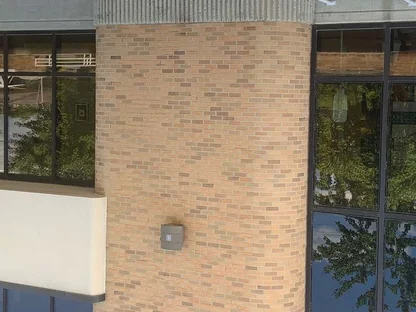 A pier and the concrete band beside it in 2014, seen from below, the brick one buff range down to the ground floor glazing