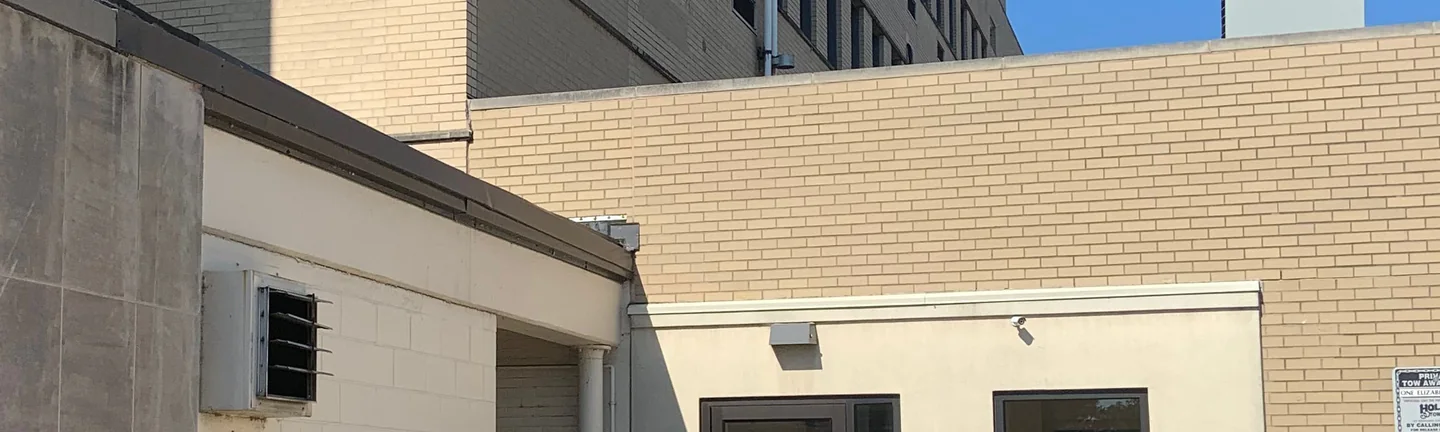 The courtyard side of an Ohio medical center in 2019, an even range of tan brick running across the single-story block