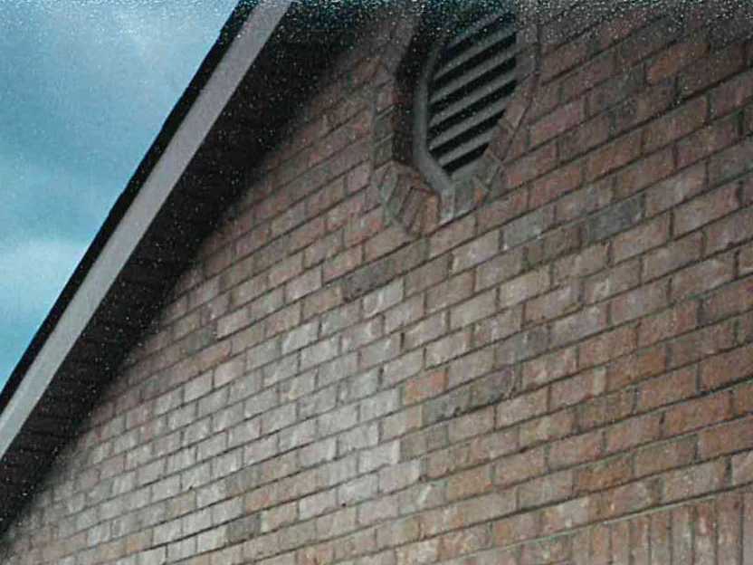 The garage gable during the 1997 work, the brick reading as a deeper red brown range under the eaves and around the louvred vent
