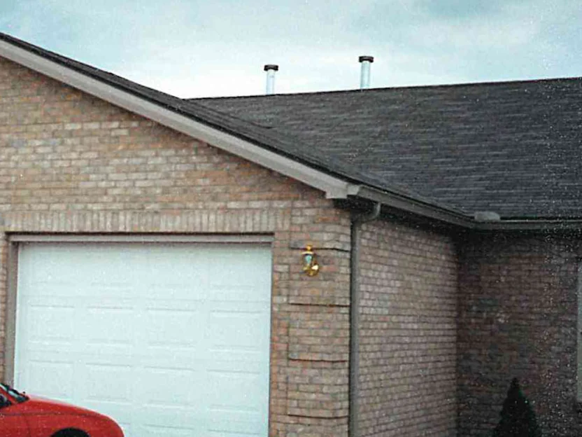 The garage end of the house in 1997, its brick a pale tan with noticeably lighter units scattered through the field
