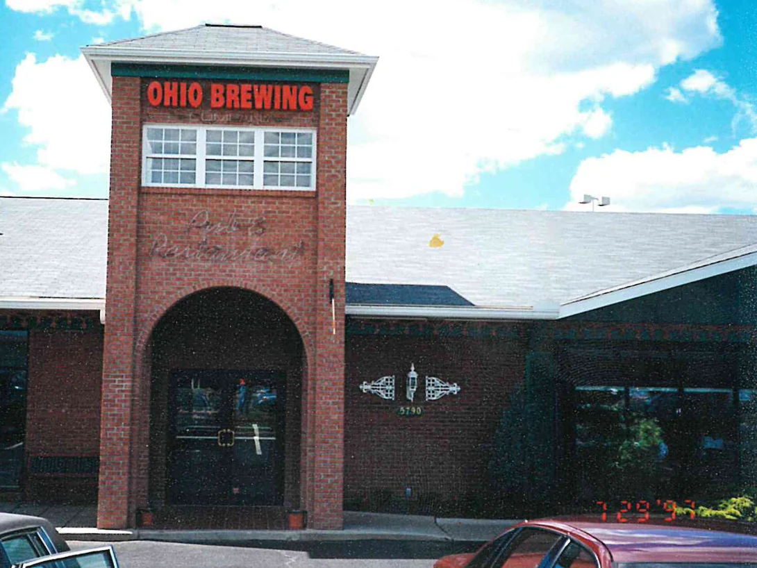 The restaurant front in 1997, a two-story brick entry tower carrying an Ohio Brewing sign above an arched doorway, with single-story wings on both sides