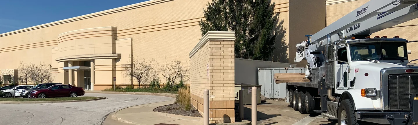 The long buff brick flank of the Ohio mall in 2019, its tan soldier bands running unbroken past the entrance canopy