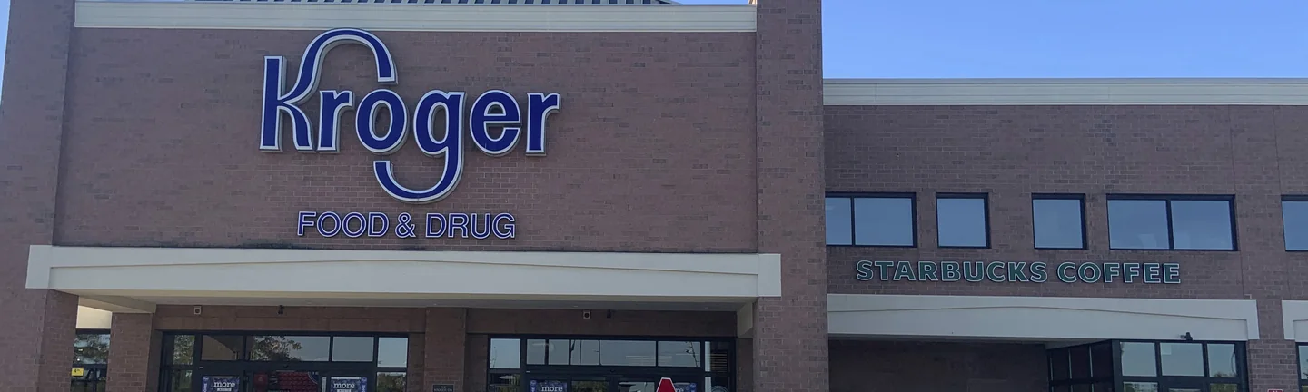 The Kroger store front in 2019, its stained brick reading as one even pink and red range
