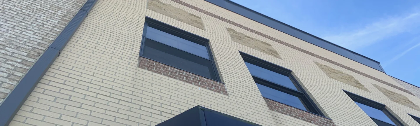 The corner of the Ohio retail building in 2019, its cream brick and mortar reading as one range across both elevations