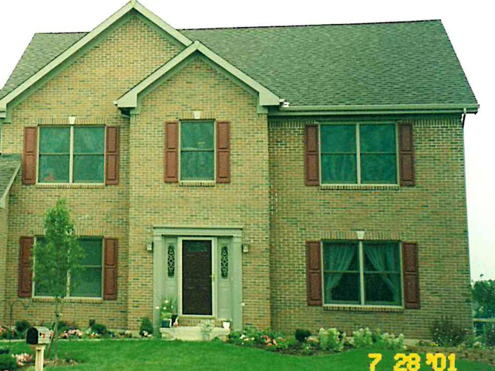 The same elevation in 2001 after the work, the light areas brought down into the range so the gable and the wall read as one mixed blend