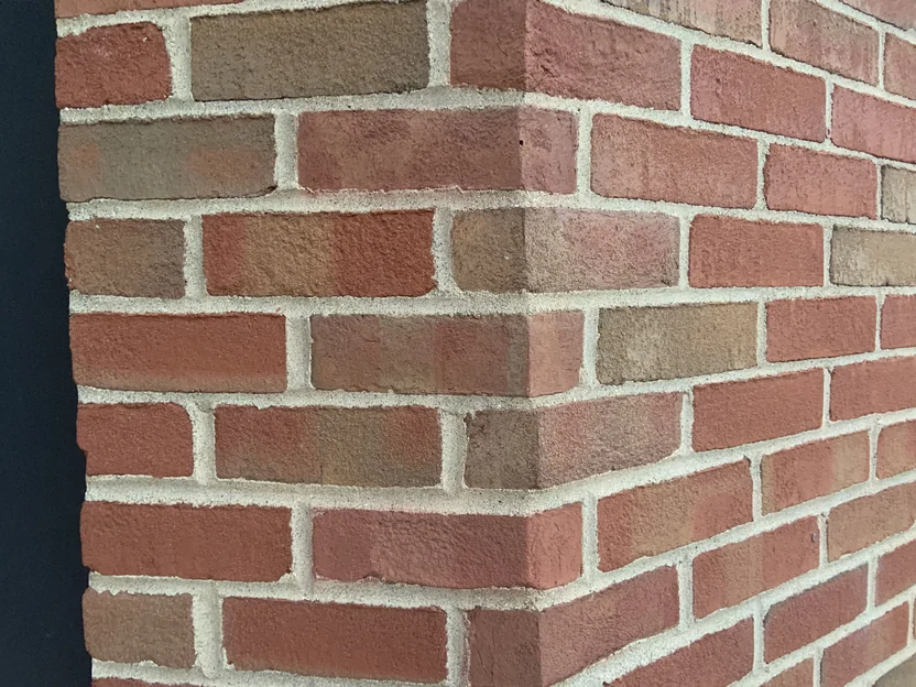 Close range on the corner shapes in 2019, the wrapped units carrying the same reds, browns and greys as the stretchers running away from the corner