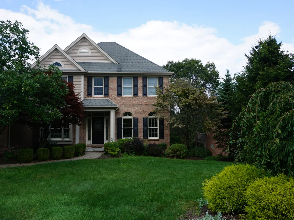 The front of the Pennsylvania house from the lawn in 2019, its brick an even red and salmon range across both storeys under the twin front gables.