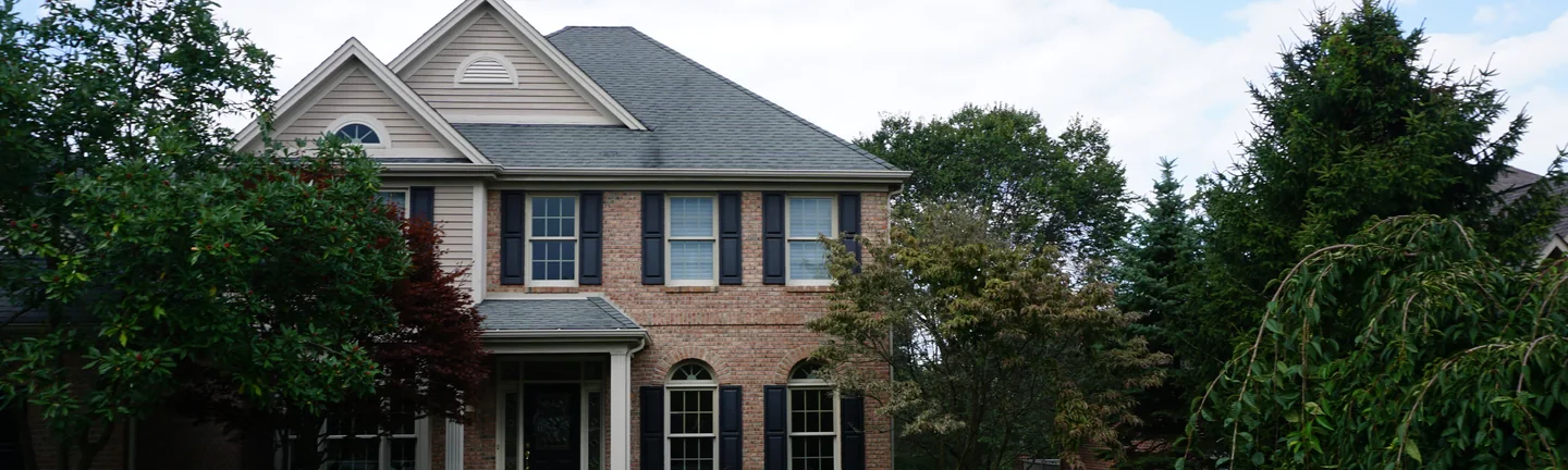 The front of the Pennsylvania house in 2019, its brick an even red and salmon range beneath the twin front gables