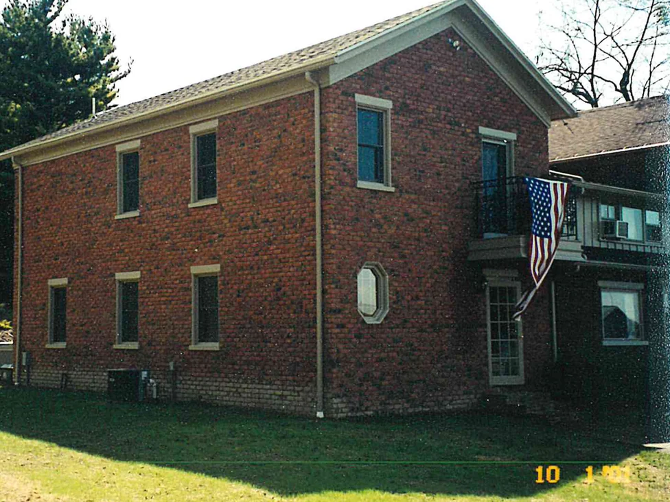 The same two walls later in 2001, the darker block gone and the brick reading as one range from the gable to the far corner