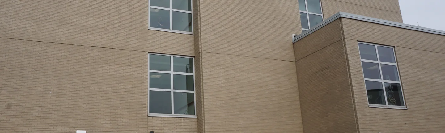 The hospital's buff brick wall in 2019, even in colour across the elevation