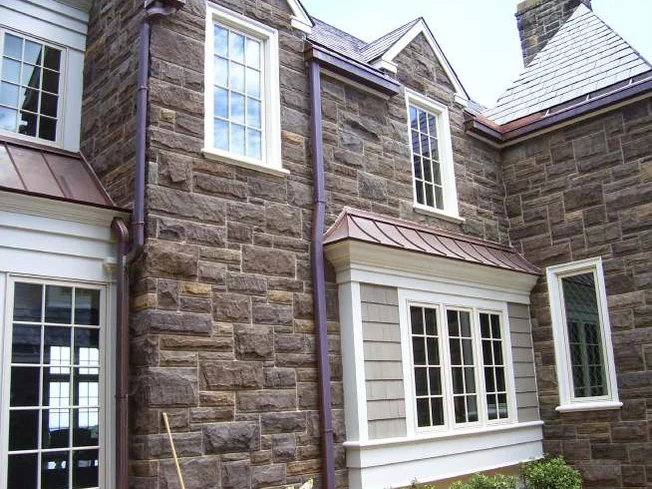The same wall in 2006 after staining, the stone around the bay window reading brown and grey across the whole elevation