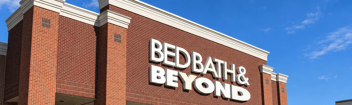 The brick front of a Bed Bath & Beyond store in 2019, the sign band running across red brick