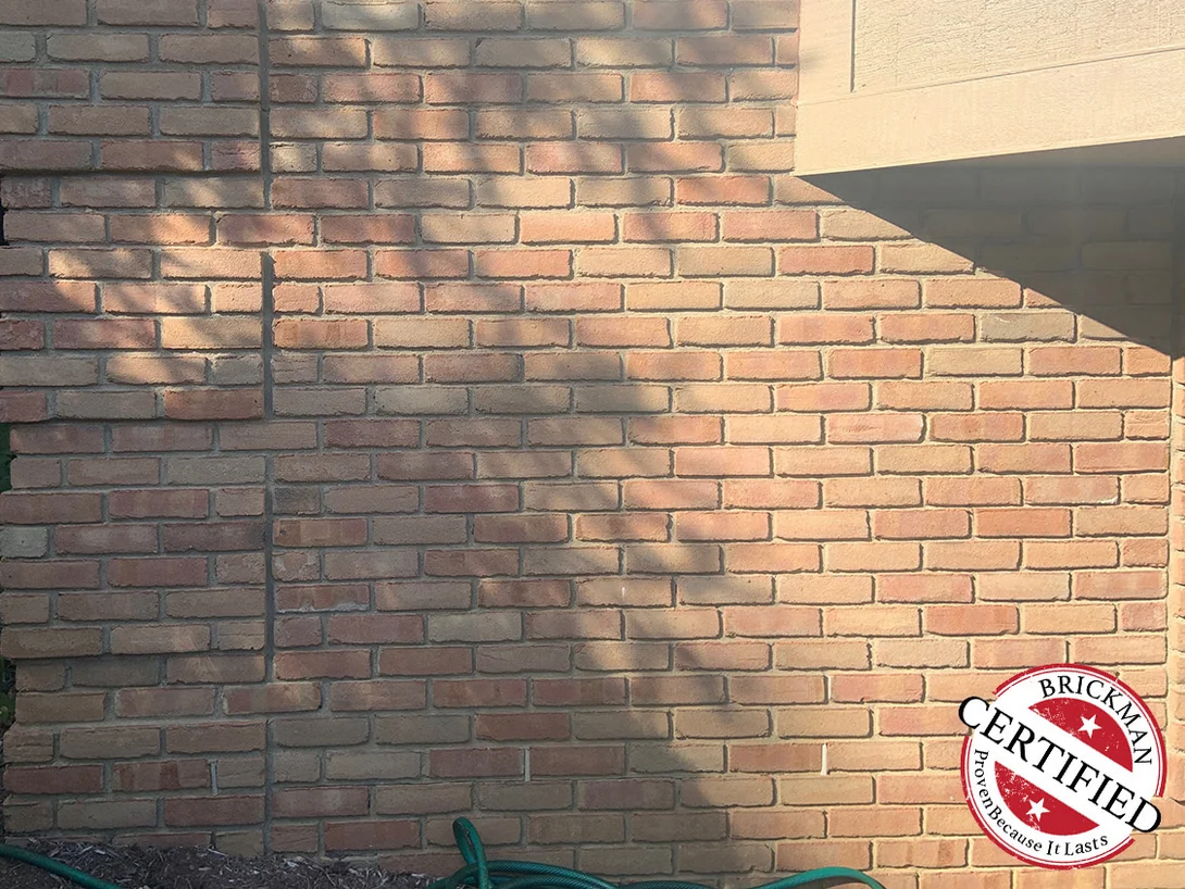 Close view of the stained brick in 2019 under the certification stamp, the units an even cream and salmon range
