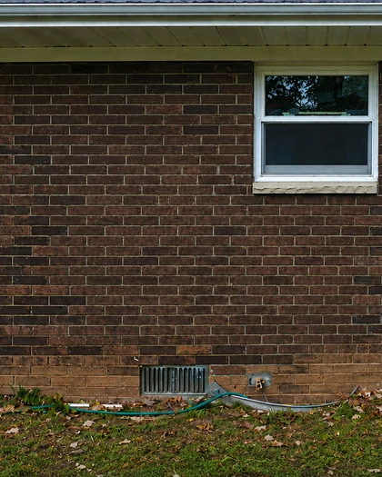 The same brick wall after staining, the replacement patch blended in to match the original masonry