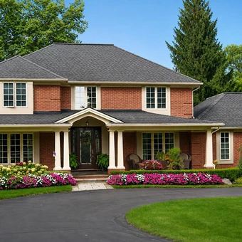 Two-story red brick home with white trim and landscaped front beds
