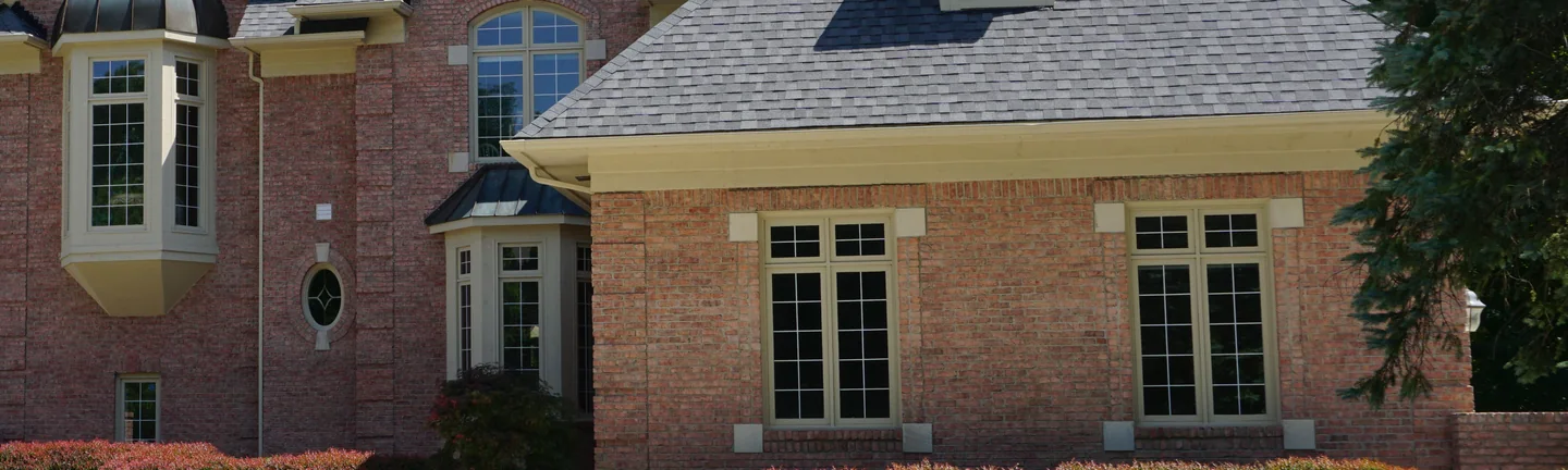 The brick front of the Rochester Hills house in 2019, reading as one even red and brown range