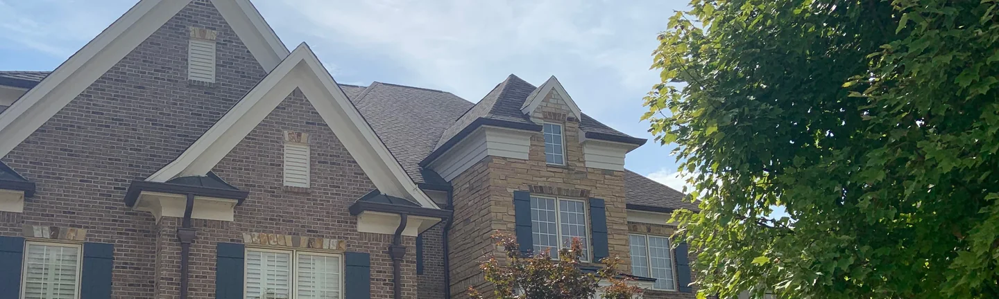 The front of the house in 2019, its brick gables and stone bay reading as one settled range