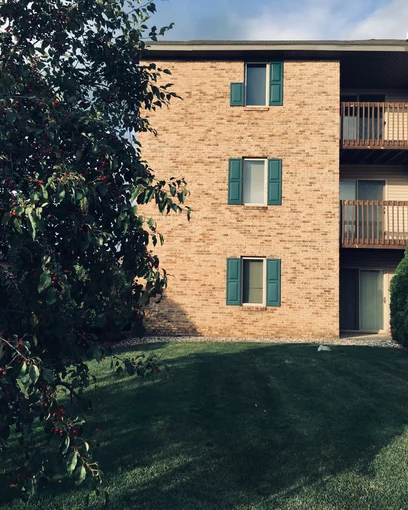 One end of a three-story Royal Vista apartment building in Michigan in 2019, its brick one even range