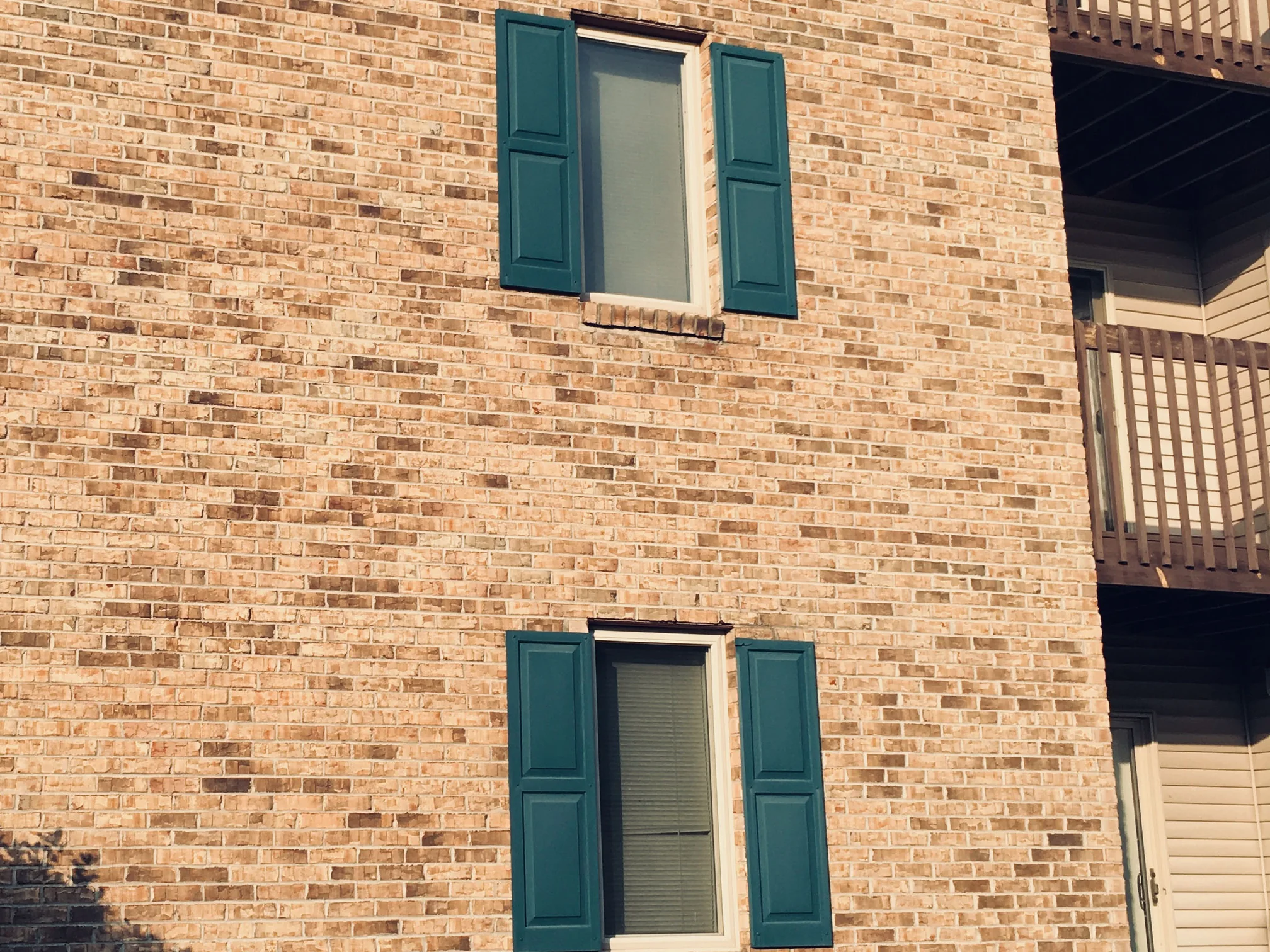 A brick end wall at Royal Vista in 2019, the buff and tan units reading as one blend from the eaves down to the stone chippings